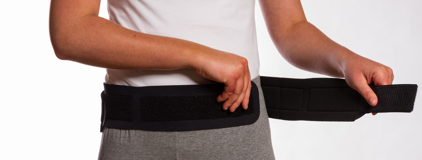 Thermoskin Sacroiliac Belt black front view putting on